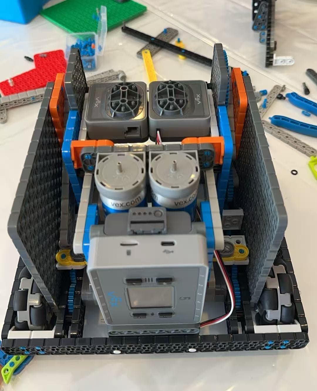 A VEX IQ chassis seen from above on the bench, motors and brain mounted inside the frame.