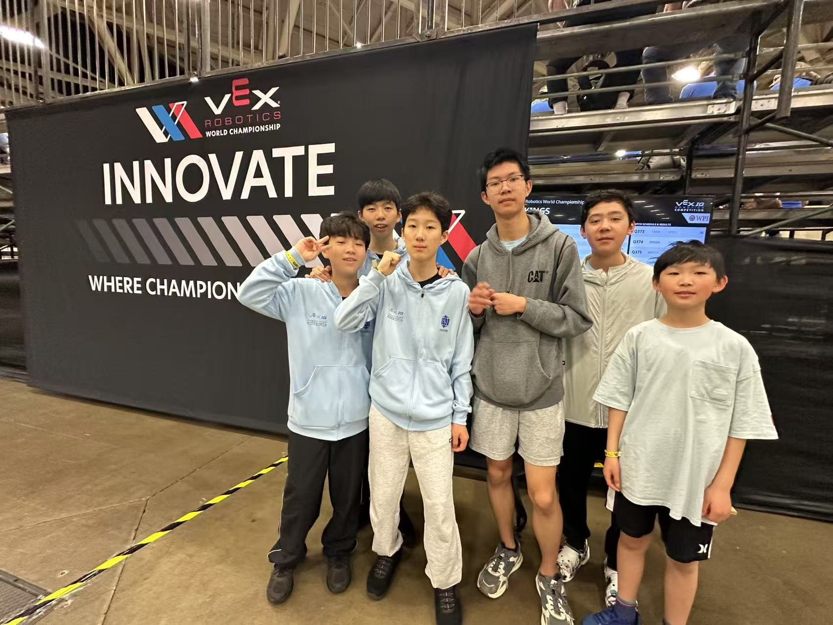 Six clubbers standing in front of the Innovate banner on the World Championship floor.
